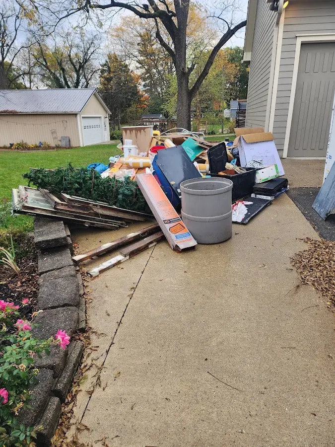 Dumpster being loaded with debris for Estate Cleanout Dumpster Rental in Rockmart